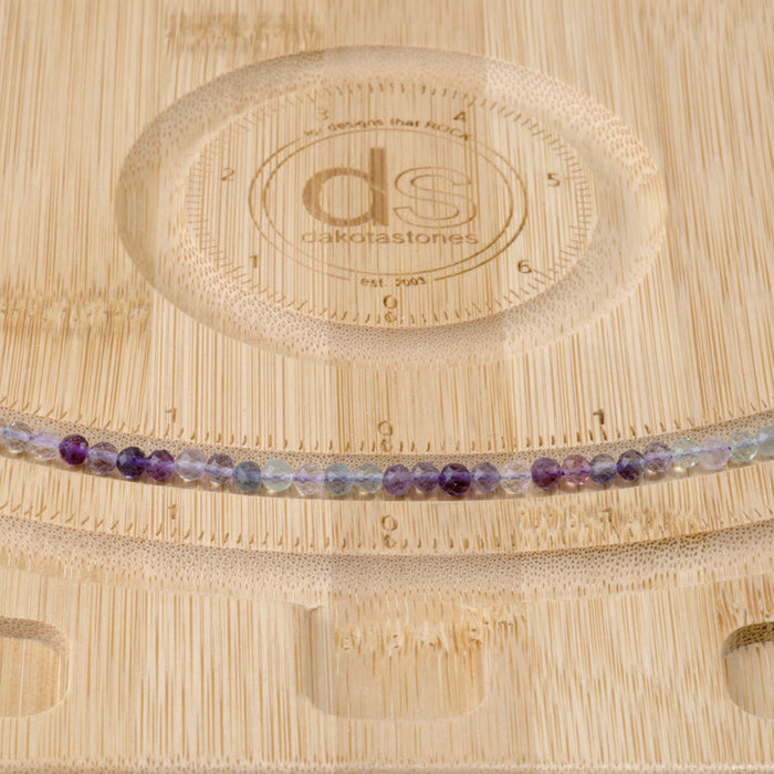 This is a Dakota Stones 4mm Rainbow Fluorite Gemstone strand with A grade microfaceted round beads in 15-16 inch strand.