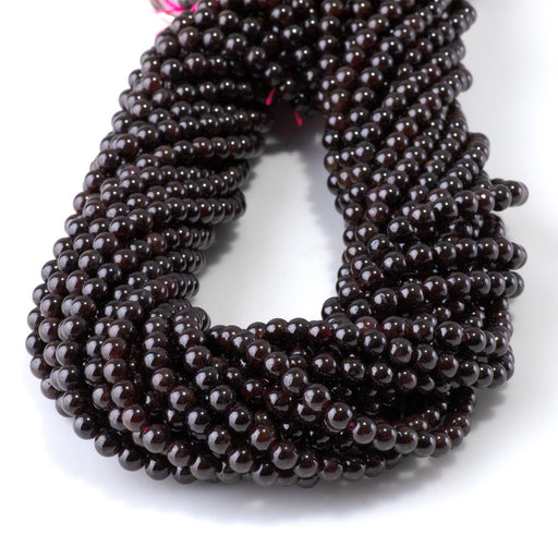 This is a Dakota Stones 4mm Red Garnet Gemstone strand with round beads in 15-16 inch strand.