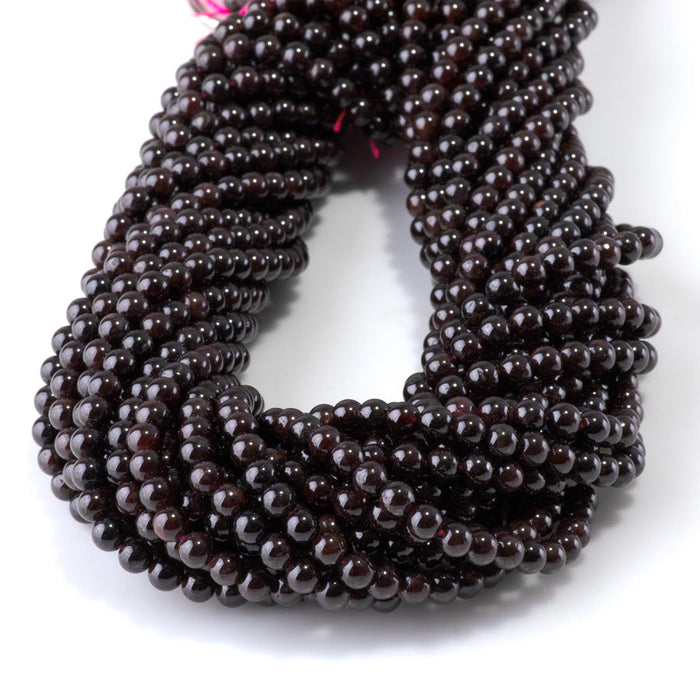 This is a Dakota Stones 4mm Red Garnet Gemstone strand with round beads in 15-16 inch strand.