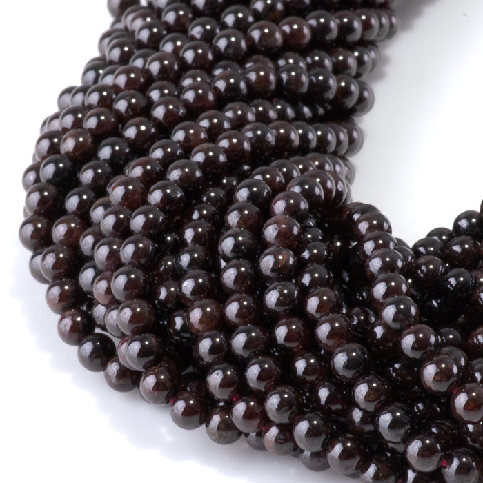 This is a Dakota Stones 4mm Red Garnet Gemstone strand with round beads in 15-16 inch strand.
