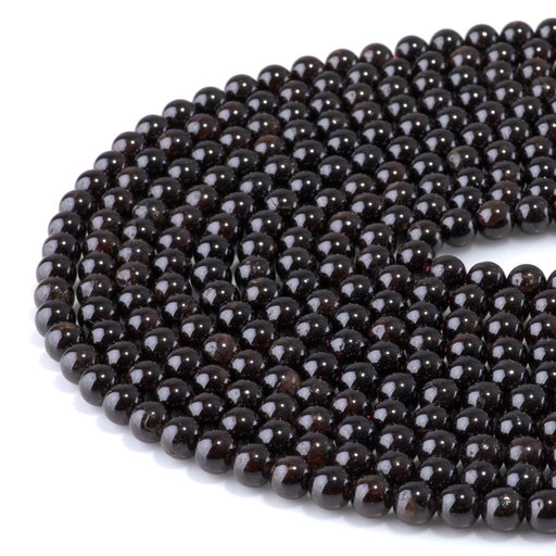 This is a Dakota Stones 6mm Red Garnet Gemstone strand with round beads in 15-16 inch strand.