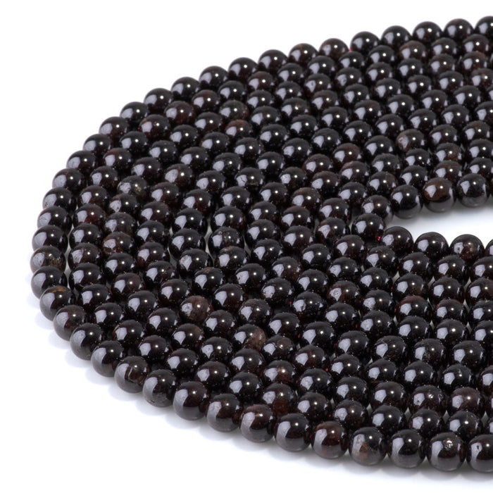 This is a Dakota Stones 6mm Red Garnet Gemstone strand with round beads in 15-16 inch strand.