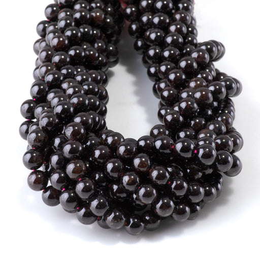 This is a Dakota Stones 6mm Red Garnet Gemstone strand with round beads in 15-16 inch strand.