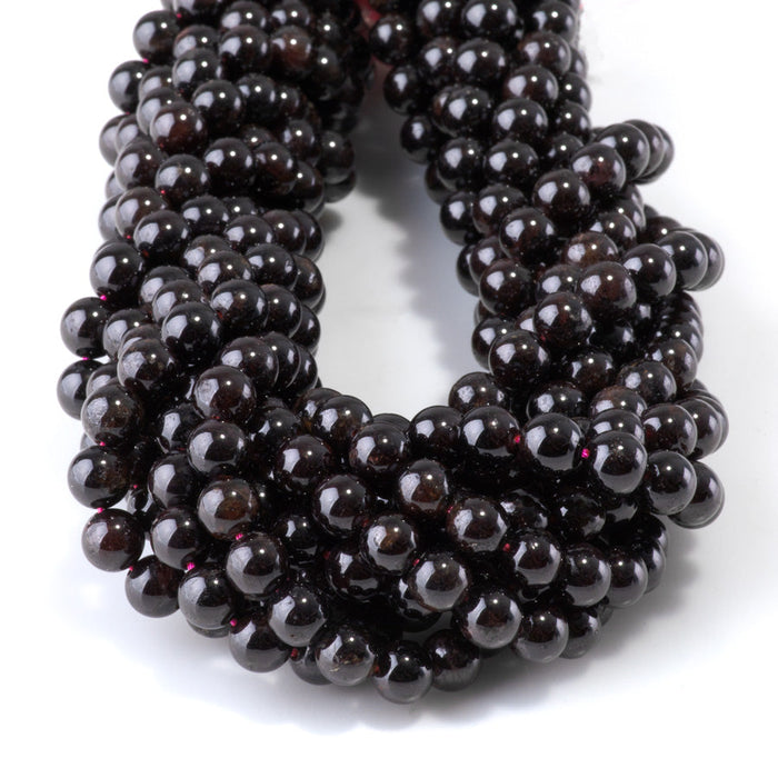 This is a Dakota Stones 6mm Red Garnet Gemstone strand with round beads in 15-16 inch strand.