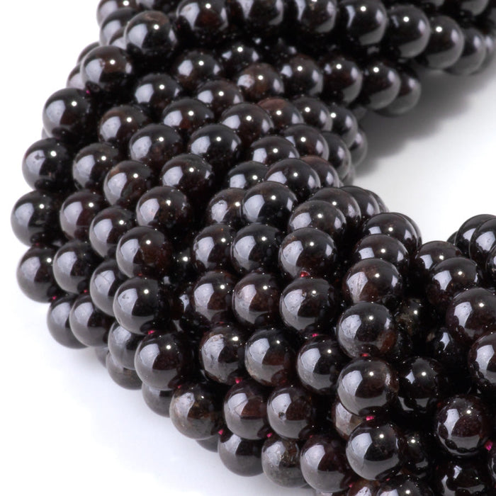 This is a Dakota Stones 6mm Red Garnet Gemstone strand with round beads in 15-16 inch strand.