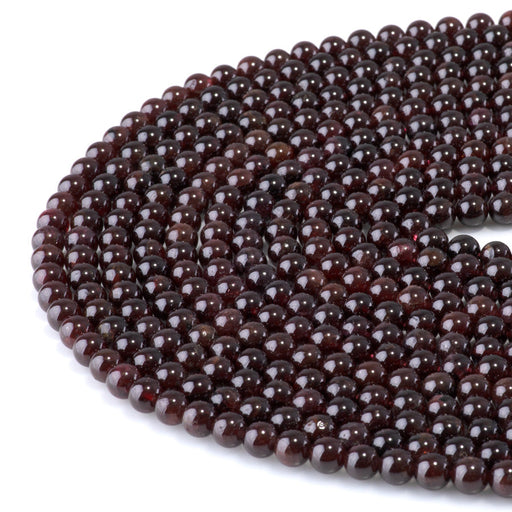 This is a Dakota Stones 6mm Red Garnet Gemstone strand with AA grade round beads in 15-16 inch strand.