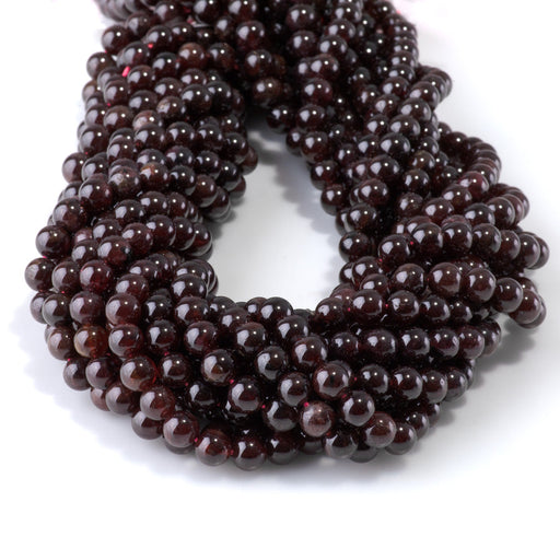 This is a Dakota Stones 6mm Red Garnet Gemstone strand with AA grade round beads in 15-16 inch strand.