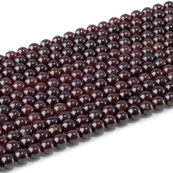 This is a Dakota Stones 6mm Red Garnet Gemstone strand with AA grade round beads in 15-16 inch strand.