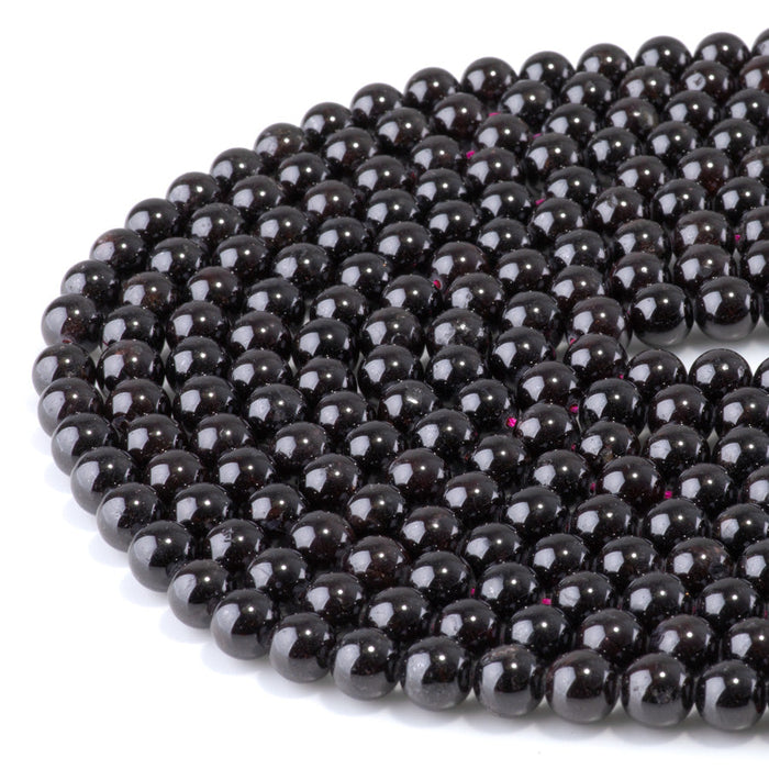 This is a Dakota Stones 8mm Red Garnet Gemstone strand with round beads in 15-16 inch strand.