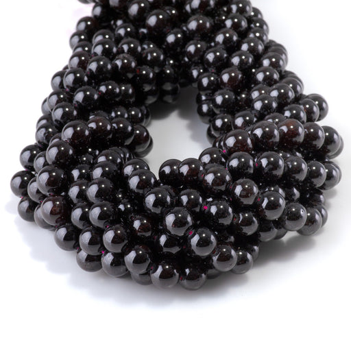 This is a Dakota Stones 8mm Red Garnet Gemstone strand with round beads in 15-16 inch strand.