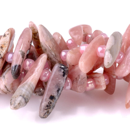 This is a Dakota Stones 5x10-20mm Rhodocrhosite Top Drill Teeth Gemstone strand of round beads in 15-16 inch strand.