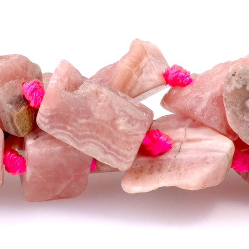 This is a Dakota Stones 8x10-10x12mm Rhodochrosite Gemstone strand with A grade rough nugget beads in 15-16 inch strand.