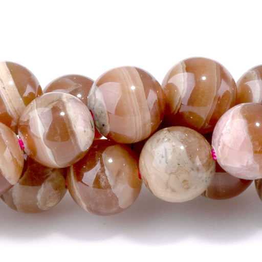 This is a Dakota Stones 8mm Rhodochrosite Wood Quartz Gemstone strand with round beads in 15-16 inch strand.