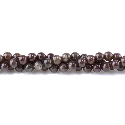 This is a Dakota Stones 8mm Scapolite Cats Eye Red Gemstone strand with round beads in 15-16 inch strand.