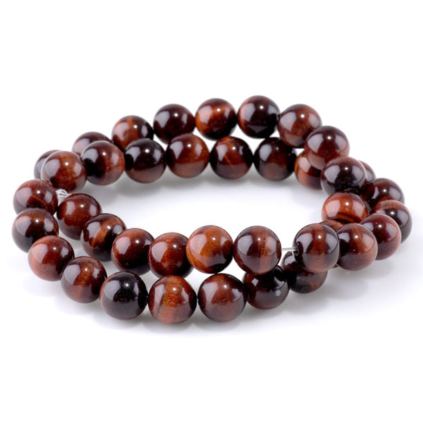 This is a Dakota Stones 10mm Red Tiger Eye Gemstone strand with round beads in 15-16 inch strand.