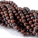 This is a Dakota Stones 6mm Red Tiger Eye Large Hole Gemstone strand with round beads in 8 inch strand.