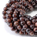 This is a Dakota Stones 6mm Red Tiger Eye Large Hole Gemstone strand with round beads in 8 inch strand.