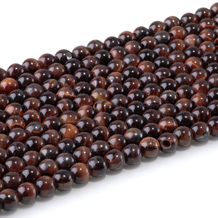 This is a Dakota Stones 6mm Red Tiger Eye Large Hole Gemstone strand with round beads in 8 inch strand.