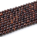 This is a Dakota Stones 6mm Red Tiger Eye Large Hole Gemstone strand with round beads in 8 inch strand.