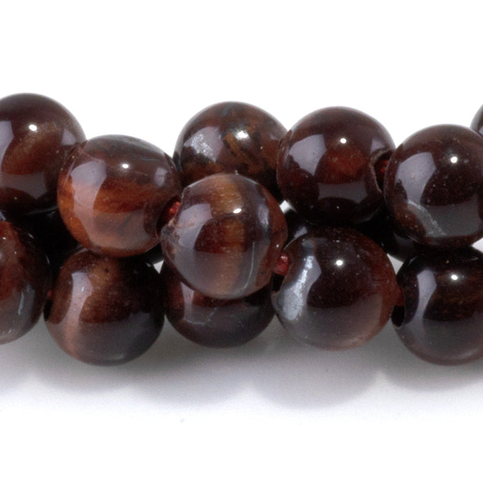 This is a Dakota Stones 6mm Red Tiger Eye Large Hole Gemstone strand with round beads in 8 inch strand.