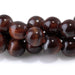 This is a Dakota Stones 6mm Red Tiger Eye Large Hole Gemstone strand with round beads in 8 inch strand.