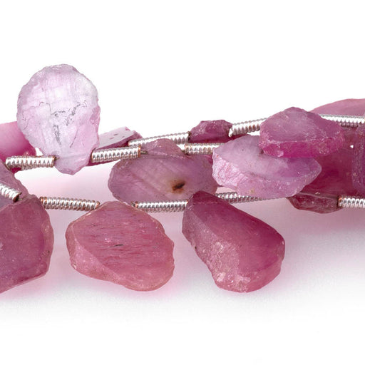 This is a Dakota Stones 7x9-12x15mm Pink Sapphire Top Drill Slice Gemstone strand with irregular beads in 8 inch strand.