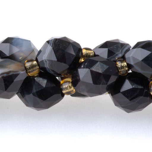 This is a Dakota Stones 6x8mm Sardonyx Triangle Cut Rice Gemstone strand with faceted beads in 15-16 inch strand.