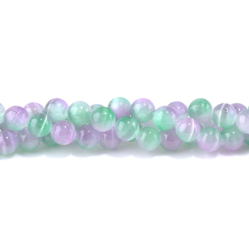 This is a Dakota Stones 10mm Selenite Green Purple Gemstone strand with dyed round beads in 15-16 inch strand.