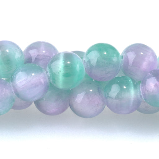 This is a Dakota Stones 6mm Selenite Green Purple Gemstone strand with dyed round beads in 15-16 inch strand.