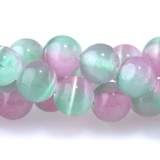 This is a Dakota Stones 8mm Selenite Green Pink Gemstone strand with dyed round beads in 15-16 inch strand.
