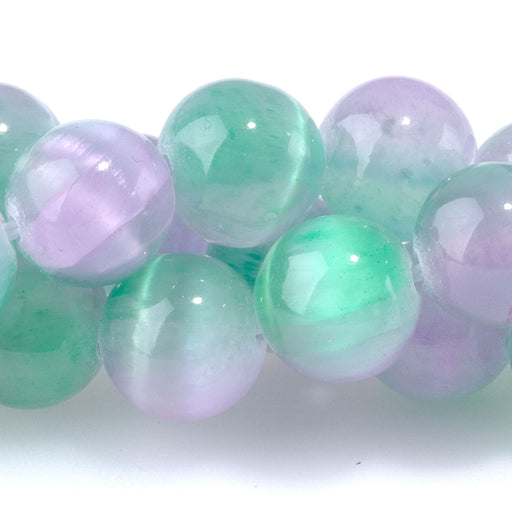 This is a Dakota Stones 8mm Selenite Green Purple Gemstone strand with dyed round beads in 15-16 inch strand.