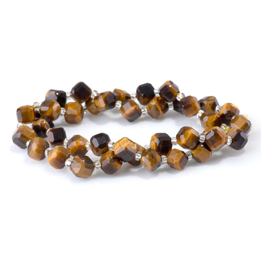 This is a Dakota Stones 6x8mm Tiger Eye Corner Gemstone strand with A grade table-cut cube beads in 15-16 inch strand.