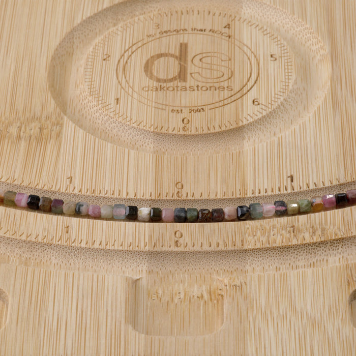 This is a Dakota Stones 3mm Multi Tourmaline Gemstone strand with table cut faceted cube beads in 15-16 inch strand.