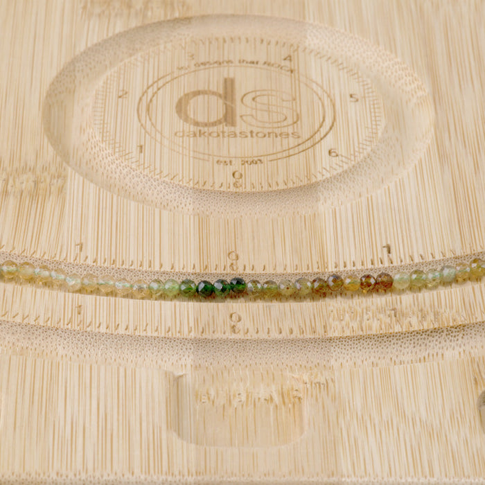 This is a Dakota Stones 3mm Yellow Green Banded Tourmaline Gemstone strand with faceted round beads in 15-16 inch strand.