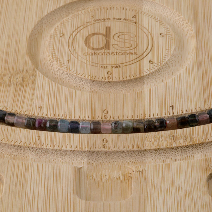 This is a Dakota Stones 4mm Multi Tourmaline Gemstone strand with A grade table cut faceted cube beads in 15-16 inch strand.
