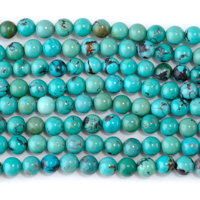 This is a Dakota Stones 6-7mm Hubei Turquoise Matrix Gemstone strand with round beads in 15-16 inch strand.