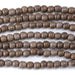 This is a Dakota Stones 6mm Gray Wood Gemstone strand with round beads in 15-16 inch strand.