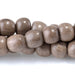 This is a Dakota Stones 6mm Gray Wood Gemstone strand with round beads in 15-16 inch strand.