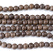 This is a Dakota Stones 8mm Gray Wood Gemstone strand with round beads in 15-16 inch strand.