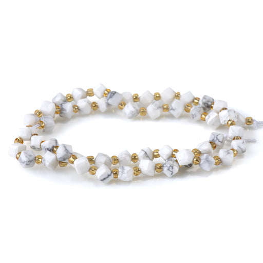 This is a Dakota Stones 4x6mm White Howlite Corner Gemstone strand with table-cut cube beads in 15-16 inch strand.