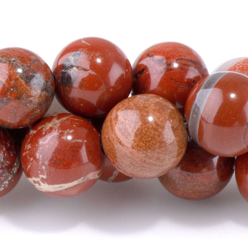 This is a Dakota Stones 10mm White Lace Red Jasper Gemstone strand with round beads in 15-16 inch strand.