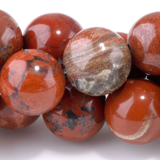 This is a Dakota Stones 12mm White Lace Red Jasper Gemstone strand with round beads in 15-16 inch strand.