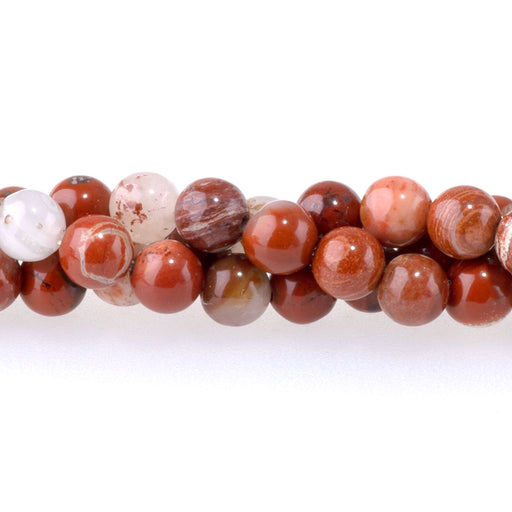 This is a Dakota Stones 4mm White Lace Red Jasper Gemstone strand with round beads in 15-16 inch strand.