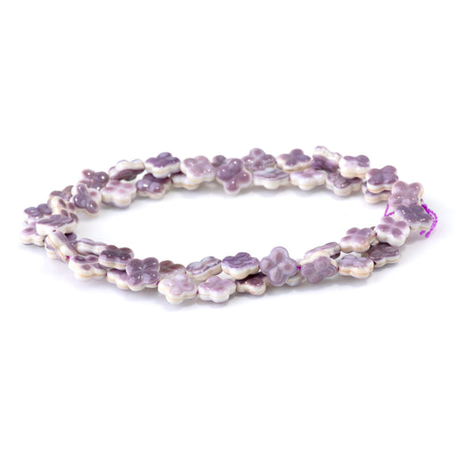 This is a Dakota Stones 8-9mm Wampum Shell Carved Clover Gemstone strand of round beads in 15-16 inch strand.