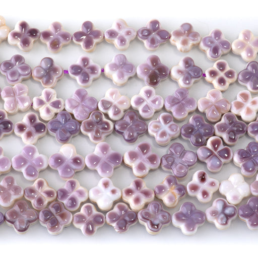 This is a Dakota Stones 8-9mm Wampum Shell Carved Clover Gemstone strand of round beads in 15-16 inch strand.
