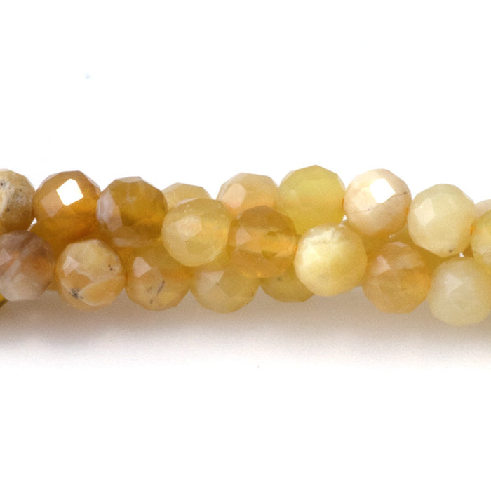 This is a Dakota Stones 4mm Yellow Opal Banded Gemstone strand with AA grade faceted round beads in 15-16 inch strand.
