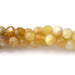This is a Dakota Stones 4mm Yellow Opal Banded Gemstone strand with AA grade faceted round beads in 15-16 inch strand.