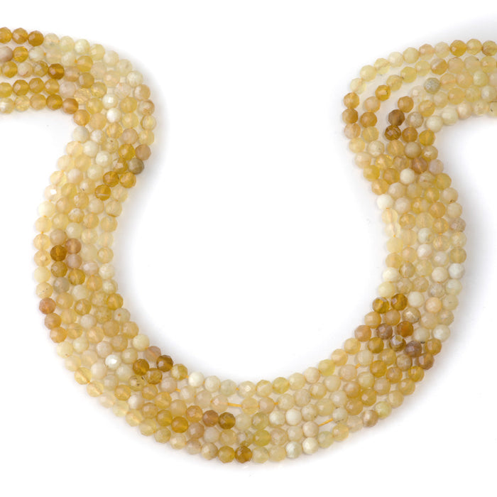 This is a Dakota Stones 4mm Yellow Opal Banded Gemstone strand with AA grade faceted round beads in 15-16 inch strand.