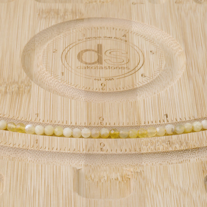This is a Dakota Stones 4mm Yellow Opal Banded Gemstone strand with AA grade faceted round beads in 15-16 inch strand.