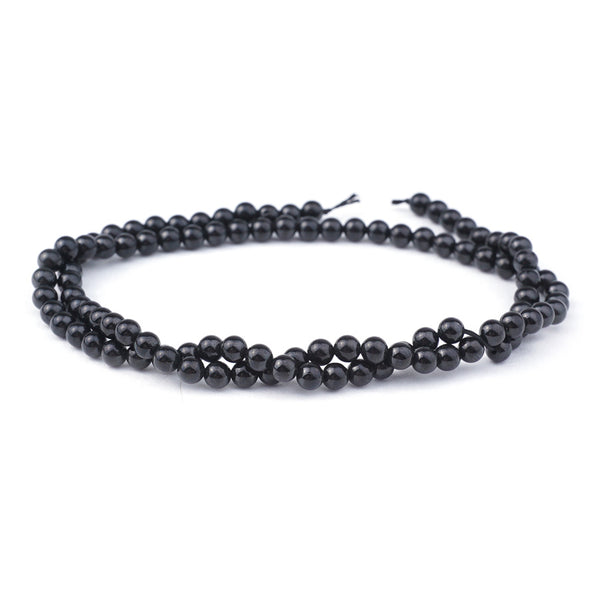 This is a Dakota Stones 4mm Black Spinel Gemstone strand with natural round beads in 15-16 inch strand.
